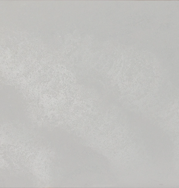A mostly empty, light gray textured surface with subtle variations and faint marks.