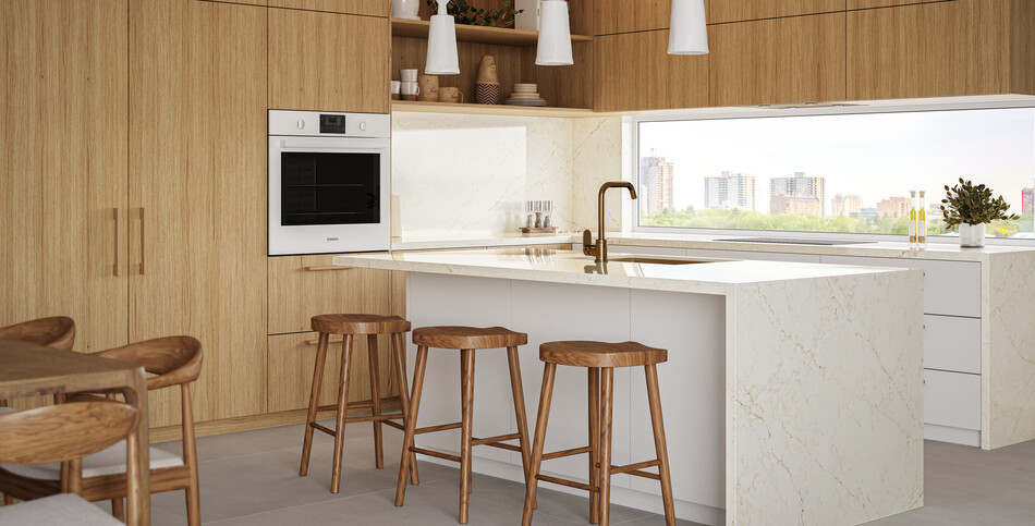 Kitchen countertop and island in Rossa Nova quartz with an off-white base with golden veins.