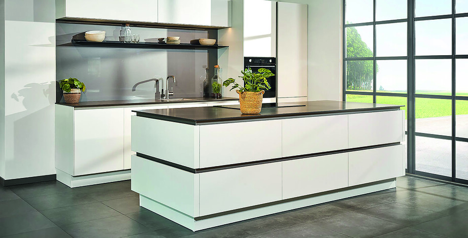 Modern kitchen with high-contrast Raven quartz countertops, white slab cabinets, and a large grid pattern floor-to-ceiling window.