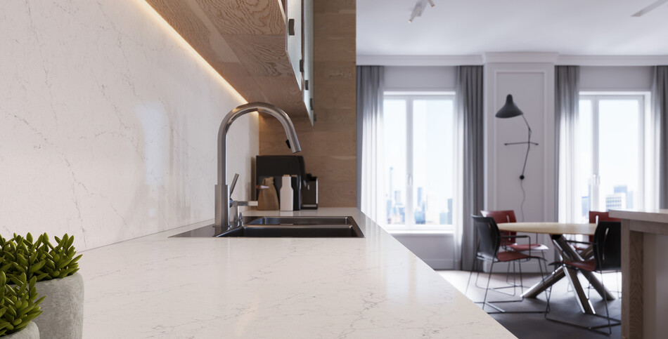 Kitchen countertop of white Dreamy Carrara quartz with fine off-white and light-gray veining.