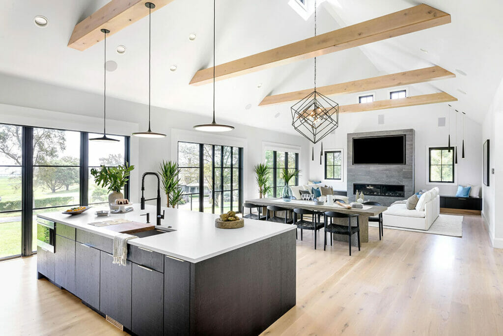 black kitchen island with white quartz countertops