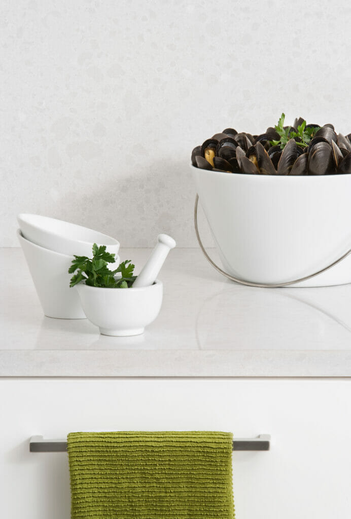 white backsplash and countertop with bucket of clam shells 