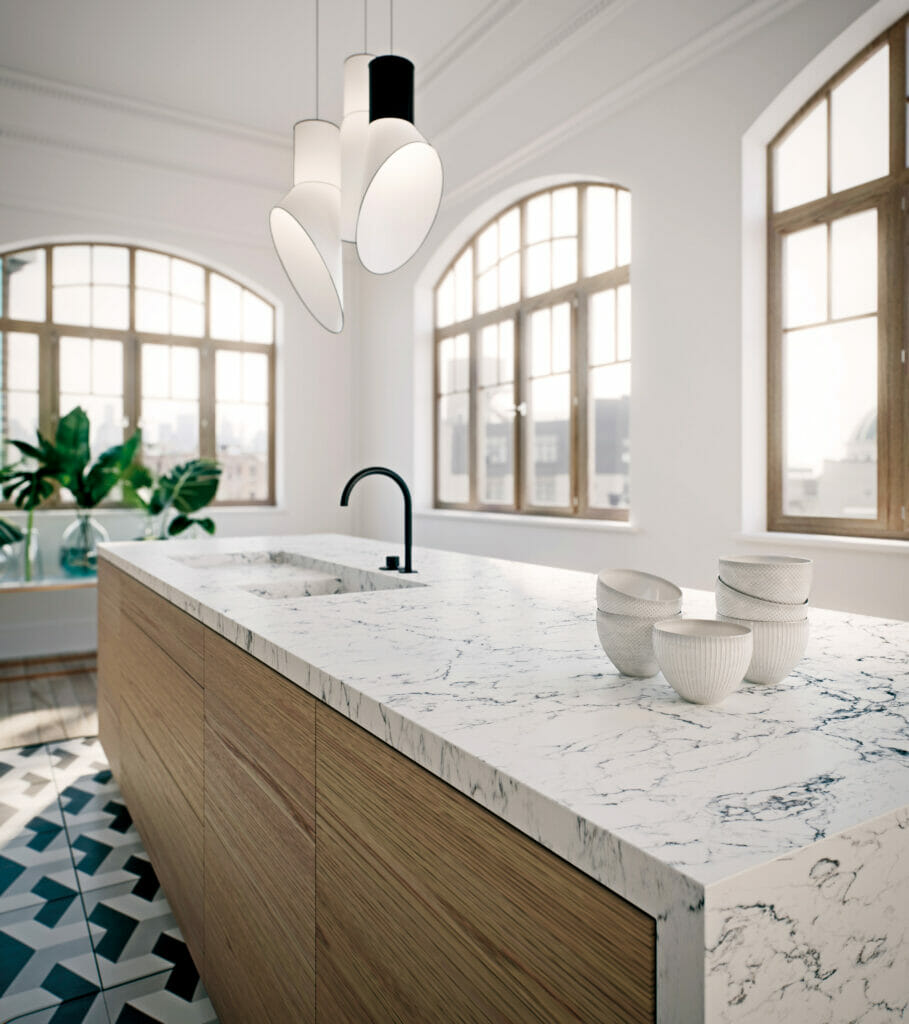 Kitchen with white with blue veins waterfall island and mosaic tile floors 