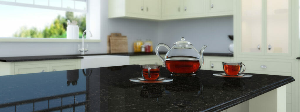 Light green kitchen with dark chocolate countertop and teapot 