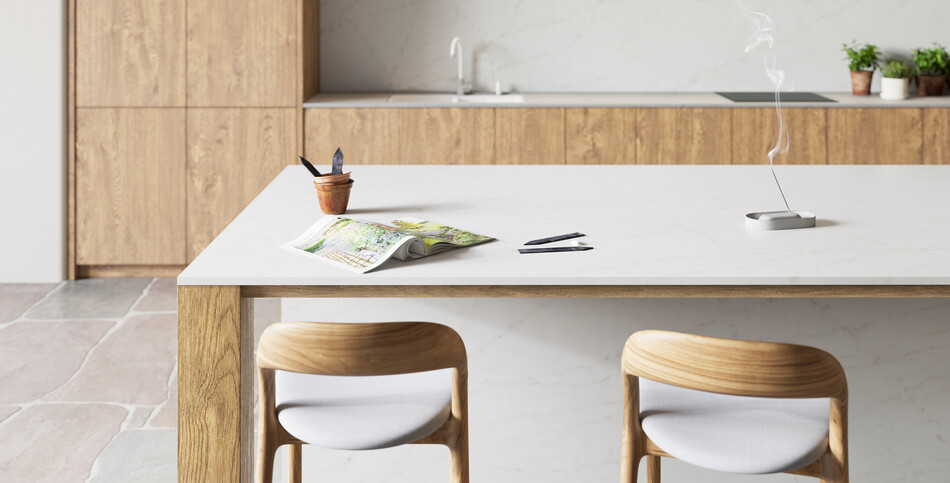 A kitchen island and countertop of white Clearlight Caesarstone ICON advanced fusion material.