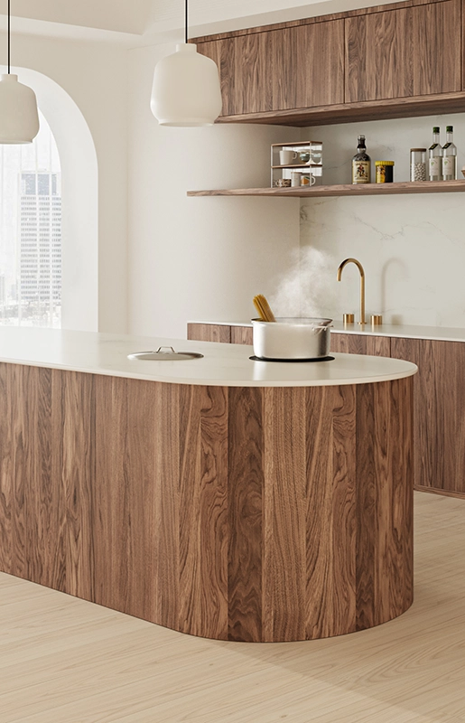 Modern kitchen with wooden cabinetry, island, steaming pot, open shelves, and cityscape view.