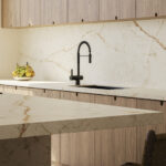 Goldesse porcelain countertop and backsplash with a soft white base, golden veins, and faint gray tinge