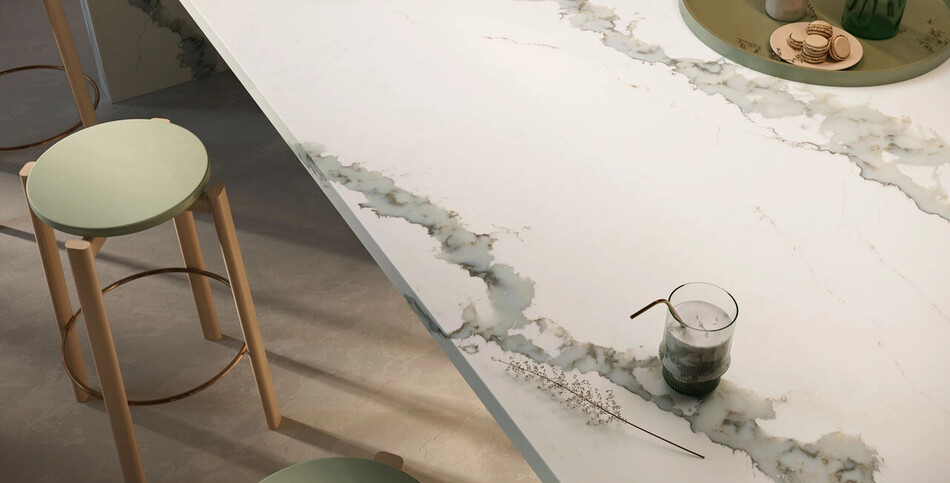 Close-up of the dramatic, thick gray and gold veining and warm white base of the Caesarstone ICON advanced fusion surface in Calacatta Thyme.